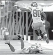  ?? John Angelillo United Press Internatio­nal ?? THE GIANTS’ Victor Cruz leaps over the Jets’ Eric Smith on his way to a 99-yard touchdown in 2011.