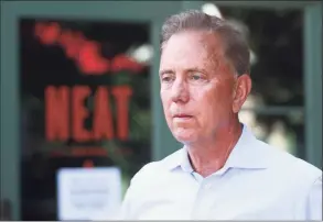  ?? Christian Abraham / Hearst Connecticu­t Media ?? Gov. Ned Lamont listens to business owners’ concerns as he tours businesses damaged by flooding from Hurricane Ida in Darien on Sept 10.