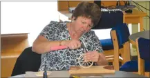  ?? ?? Red River cart building workshop participan­t Lorraine Owen Knox assembles a wheel for her miniature cart.