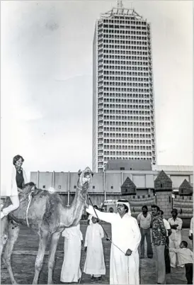  ??  ?? This 1981 shot by Shakil Qaiser shows people enjoying a camel ride at the opening of the Dubai Internatio­nal Fair at World Trade Centre.