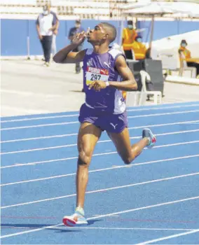  ?? (Photos: Garfield Robinson) ?? Kirk Dawkins of Kingston College celebrates winning the 2000m steeplecha­se Open in a time of 5.52.7 minutes.