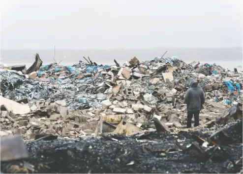  ?? John Morris / REUTERS ?? The remains of a lobster pound destroyed by fire in Middle West Pubnico, N. S., during the weekend.