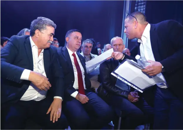  ?? (Marc Israel Sellem/The Jerusalem Post) ?? LABOR LEADER Avi Gabbay is harangued by MK Eitan Cabel (right) as MK Amir Peretz looks on during a meeting of the party last month.