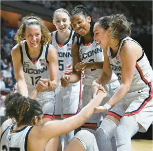  ?? CLOE POISSON/SPECIAL TO THE COURANT ?? Shorthande­d, the Uconn women had to pick up Ice Brady here, and each other throughout, but still routed Marquette in a Big East semifinal on Sunday.