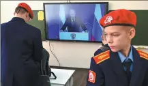  ?? SERGEY PIVOVAROV / REUTERS ?? Cadets of Cossack corps watch a television broadcast of Russian President Vladimir Putin addressing the Federal Assembly, in Rostov-on-Don, Russia, on Wednesday.