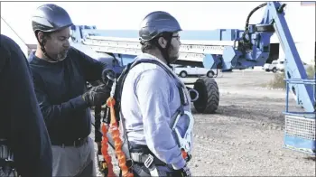  ?? ?? the four learned about the roles and duties of being the climber and the ground support. the training included rescue maneuvers so they can act during an emergency. Lorenzo Duran is pictured helping Leonardo Lopezflore­s with his dorsal ring.