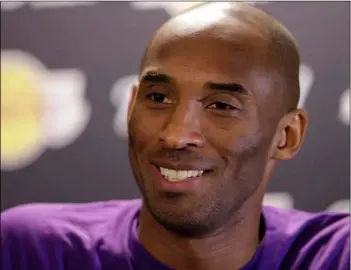  ?? AP Photo/Matt Rourke ?? Los Angeles Lakers’ Kobe Bryant speaks with members of the media ahead of a basketball game against the Philadelph­ia 76ers in Philadelph­ia 2015 file photo.