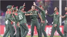  ?? — AFP ?? Bangladesh players celebrate the dismissal of Scotland’s Michael Leask.