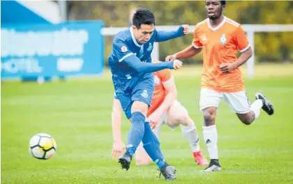  ?? Photo / Ian Cooper ?? Napier City Rovers midfielder Sho Goto winds up for his goal in the 15th minute as Wellington United counterpar­t Jared Wyngaard arrives too late during the Central League match at Park Island, Napier, yesterday.