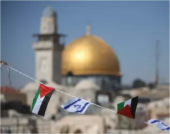  ?? (Marc Israel Sellem/The Jerusalem Post) ?? ISRAELI AND Palestine flags fly over the Western Wall and the Dome of the Rock.