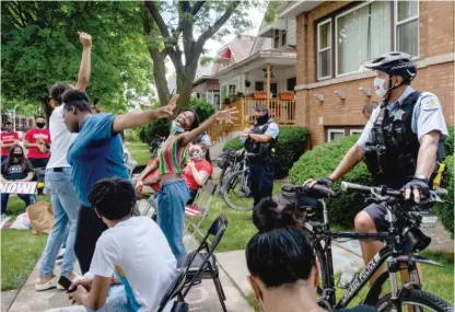  ?? PAT NABONG/SUN-TIMES ?? Youth activists dance in front of Chicago Board of Education President Miguel del Valle’s home in June to demand an end to police presence in Chicago Public Schools.