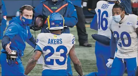  ?? COACH SEAN McVAY Steph Chambers Getty Images ?? greets running back Cam Akers after his touchdown gave the Rams a 20-10 lead late in the second quarter against the Seahawks. Akers rushed for 131 yards, and the Rams probably would need a strong (frozen) ground game to win at Lambeau Field.