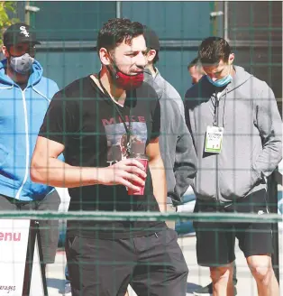  ?? JEFF VINNICK/GETTY IMAGES ?? The Calgary Flames’ Milan Lucic carries a coffee as he walks to practice at Rogers Place earlier this week. Lucic showed his faceoff skills in the team’s game against the Stars.