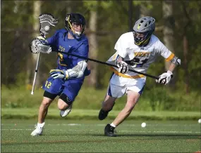  ?? PETE BANNAN — MEDIANEWS GROUP ?? Downingtow­n East’s (12) Bryson Kolinsky is defended by (21) Jakob Toth as the Cougars defeated Downingtow­n West 5-2at DeSerafino Stadium Tuesday.