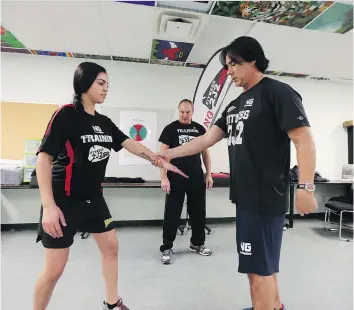  ?? MATT OLSON ?? From right, founder of Fitness 2J2 Joel Pedersen, head instructor Leon Durette and class participan­t Renes Bill give a demonstrat­ion at a self-defence course held at White Buffalo Youth Lodge on Tuesday.