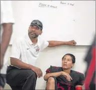  ?? Brian van der Brug Los Angeles Times ?? TODD McNAIR and Village Christian players listen to last-minute instructio­ns in the locker room.