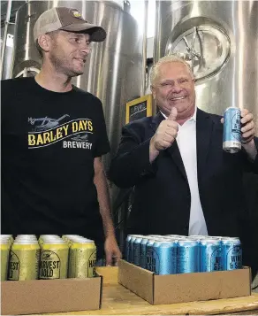  ?? LARS HAGBERG / THE CANADIAN PRESS ?? Ontario Premier Doug Ford with Barley Days employee Kyle Baldwin before announcing the buck-a-beer plan at Barley Days brewery in Picton, Ont., on Tuesday.