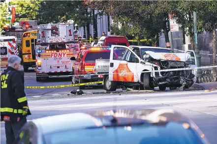  ?? CHANG W. LEE/THE NEW YORK TIMES ?? New York City police officers respond to the scene where a man mowed down several people on a bike path Tuesday in New York City. Authoritie­s identified the motorist as Sayfullo Saipov, 29.
