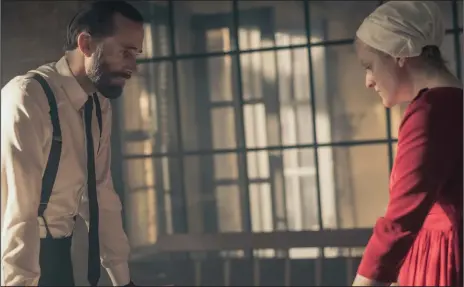  ?? George Kraychyk/Hulu ?? Commander Waterford (Joseph Fiennes) and Offred (Elisabeth Moss) in Season 2 of “The Handmaid’s Tale.”