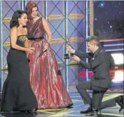  ??  ?? Debra Messing (C) and Chris Hardwick present the award for Outstandin­g Lead Actress in a Comedy Series to Julia Louis Dreyfus (L) for Veep