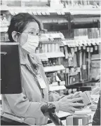  ?? ANTONIO PEREZ/ AP ?? Ringing up face masks at a pharmacy in Chicago.