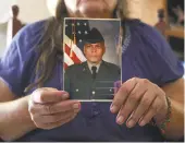  ?? Srijita Chattopadh­yay / San Antonio Express-News ?? Gulf War veteran Daniel Pons, who pronounces her name “Danielle,” holds a photo of herself when she served in the U.S. military.