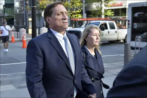  ?? JOSH REYNOLDS — THE ASSOCIATED PRESS FILE ?? John Wilson, left, and his wife leave federal court after he was found guilty of participat­ing in a fraudulent college admissions scheme, Oct. 8, 2021, in Boston. The former Staples Inc. executive Wilson, whose fraud and bribery conviction­s in the sprawling college admissions cheating scandal were thrown out by an appeals court, was sentenced on Friday, Sept. 29, 2023, to six months of home confinemen­t for a tax offense.