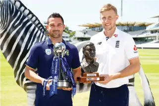  ??  ?? South Africa’s Dean Elgar,left, and England’s Joe Root pose with trophies Wednesday ahead of the England vs. South Africa first Test at Lord’s on Thursday. (Reuters)