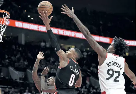  ?? STEVE DYKES/THE ASSOCIATED PRESS ?? Portland Trail Blazers guard Damian Lillard drives to the basket on Toronto Raptors centre Lucas Nogueira during the third quarter of an NBA basketball game, in Portland, Ore., on Monday. The Raptors won 99-85.