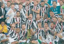  ?? — AFP ?? Juventus’ players celebrate with the trophy after winning the Italian Tim Cup (Coppa Italia) final at the Olympic Stadium on Wedneday in Rome.