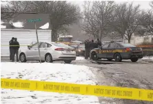  ?? Tom Dodge / Columbus Dispatch ?? Police and deputies examine the scene of an attack in Westervill­e, Ohio, where two officers were fatally shot.