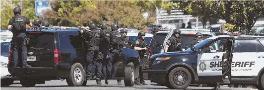  ?? APPHOTOS ?? CRIME SCENE: Law enforcemen­t officers in tactical gear arrive at a hotel in Sacramento, Calif., yesterday following a shootout that left 21-year sheriff’s deputy Robert French dead and two highway patrol officers wounded.