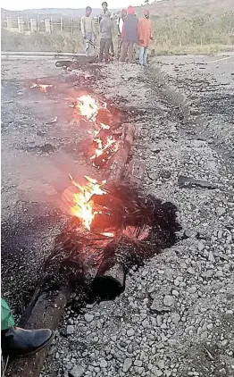  ??  ?? FLAMING BARRIER: The R61 road between Libode and Port St Johns was blockaded by protesting villages near Ntsimbini on Thursday morning, stopping the flow of traffic.