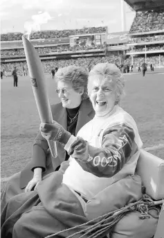  ??  ?? Betty Cuthbert carries the Olympic Torch at the Melbourne Cricket Ground in Melbourne June 5, 2004 file photo. — Reuters photo