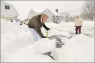  ?? JON C. HANCOCK/ ASSOCIATED PRESS ?? In Virginia, Joe and Linda Bays confronted heavy snow that continued to fall throughout the day thanks to Sandy.