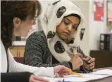  ?? BERNARD WEIL/TORONTO STAR ?? Eastern Commerce Collegiate student Sytra Mohammed discusses school subject choices with vice-principal Leonor Lopes. The Toronto public board is quietly shutting down Eastern Commerce.