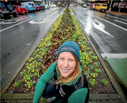  ?? PHOTOS: ROBERT KITCHIN/STUFF ?? Wellington City Council horticultu­re team leader Phillipa Garratt among the silverbeet beds running along Lambton Quay’s traffic islands.