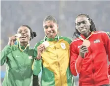  ?? — AFP photo ?? Women's 800m Olympic champion Caster Semenya (centre) could be classified as "biological­ly male" under new IAAF rules.