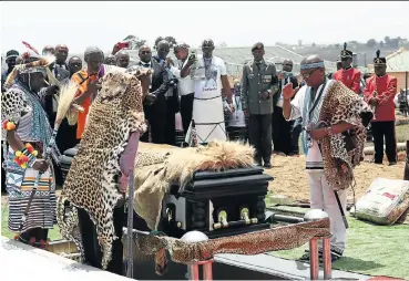  ?? Pictures: Masi Losi ?? Chiefs salute the casket of the late Xhosa king, Mpendulo Sigcawu, which was draped in a leopard skin and a lion skin, during his funeral at Nqadu Great Place on Friday.