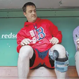  ?? STAFF PHOTO By MATT STONE ?? SORE SUBJECT: Steven Wright sports a heavy brace on his left knee in the Red Sox dugout before last night’s game. Wright said he will undergo season-ending surgery on the knee.