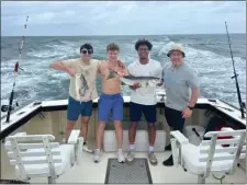  ?? COURTESY PHOTO FROM JOSHUA MARTIN ?? Those on board the Cape Cod charter boat who saw a shark grab a striped bass. The striper’s head remained. From left, Will Meyers, Zach Martin, Braeden Voyticky, and Joshua Martin.