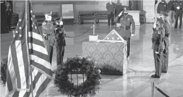  ?? ANNA MONEYMAKER/THE NEW YORK TIMES ?? Capitol Police officers pay respects to Officer Brian Sicknick in the Capitol on Feb. 3. The Justice Department has charged two men in the assault on Sicknick.