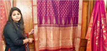  ??  ?? Tanushree Agarwal showcasing a sari, estimated to be around 200-250 years old, is priced around `2.5 lakh. The zari used is real gold and the border shows a hunting scene