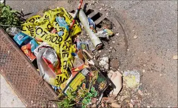  ?? Will Waldron / Times Union ?? Fireworks debris was swept into a pile Monday along Hulett Street in Schenectad­y.