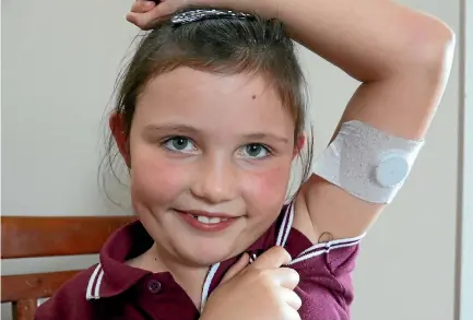  ?? PHOTO: HAMISH MCNEILLY/STUFF ?? Olivia McKenzie, 7, who has type 1 diabetes, shows off her flash glucose sensor, which is used to measure her glucose levels.