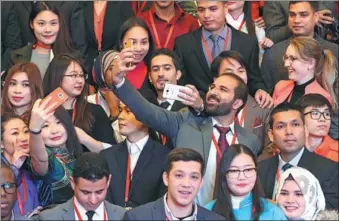  ?? ZOU HONG / CHINA DAILY ?? Internatio­nal students who are beneficiar­ies of the Chinese Government Scholarshi­p take selfies at the Great Hall of the People in Beijing on Thursday. A total of 100 students from 40 countries who are studying in China were invited by the China...