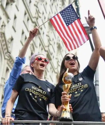  ?? Angela Weiss/Getty Images ?? Alex Morgan, right, led members of the World Cup-winning U.S. women’s soccer team which sued the U.S. Soccer Federation in federal court. At left is Megan Rapinoe.