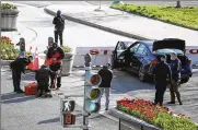  ?? ALEX BRANDON / AP ?? Authoritie­s investigat­e the scene after a man rammed a car into two officers at the barricade on Capitol Hill in Washington on Friday.