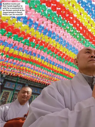  ??  ?? Buddhist monks put their hands together to wish for a successful inter-Korean summit at the Jogye temple in Seoul. Photo: Lee Jin-man/AP