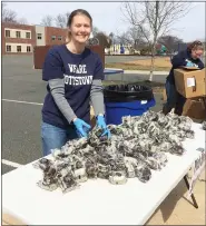  ?? EVAN BRANDT — MEDIANEWS GROUP ?? Kim Brown, Pre-K Counts coordinato­r with Pottstown schools, sported her ‘We Are Pottstown’ T-shirt as she prepared more food for distributi­on at Franklin Elementary School to borough families Wednesday.